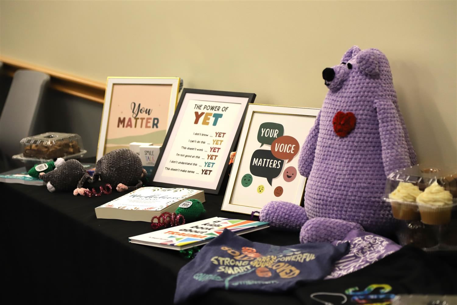 Affirming message posters on display at a table at the GIPS Mental Health Summit reading: "Your Voice Matters".